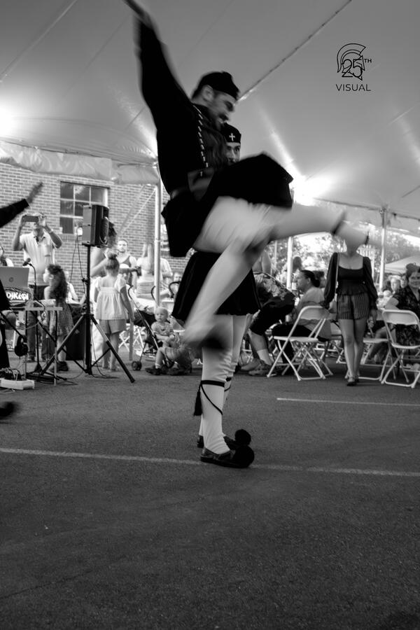 A man in traditional macedonian costume, in the middle of a tsamiko greek dance, doing a "figoura" or special kick. A man in traditional macedonian costume, in the middle of a tsamiko greek dance, doing a "figoura" or special kick.