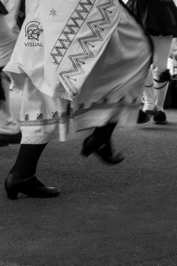 The quick movement of a traditional greek dance captured in black & white. The quick movement of a traditional greek dance captured in black & white.